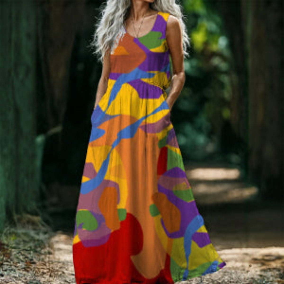 Woman wearing a colorful patterned dress standing in a natural setting.